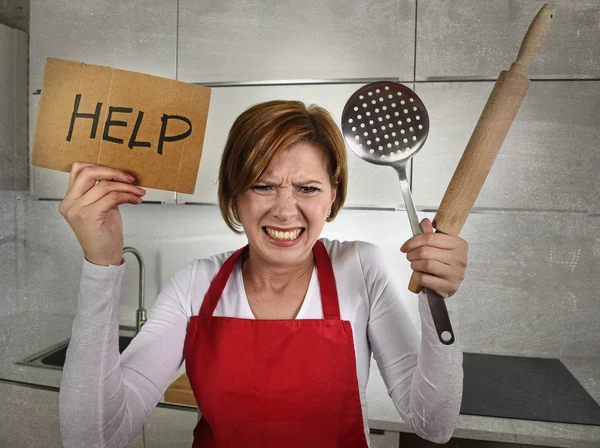 Desperate inexperienced home cook woman crying in stress desperate holding rolling pin and help sign — Zdjęcie stockowe