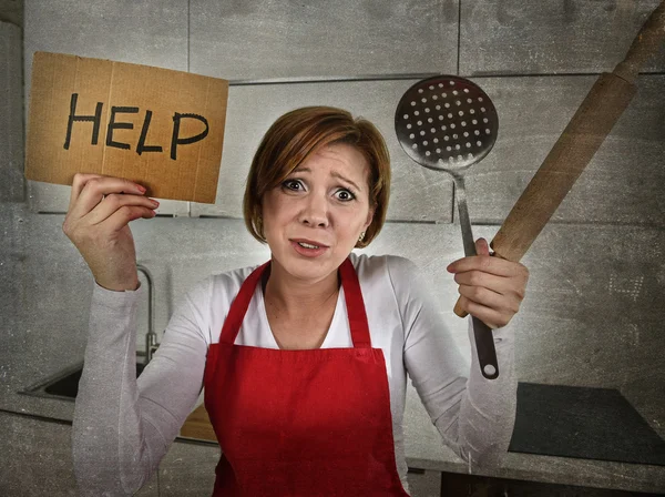 Desperate inexperienced home cook woman crying in stress desperate holding rolling pin and help sign — Stok fotoğraf