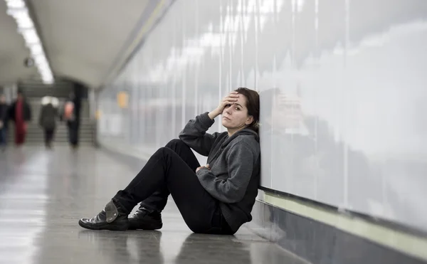 Young sad woman in pain alone and depressed at urban subway tunn — Stok fotoğraf