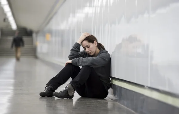 Young sad woman in pain alone and depressed at urban subway tunn — Φωτογραφία Αρχείου