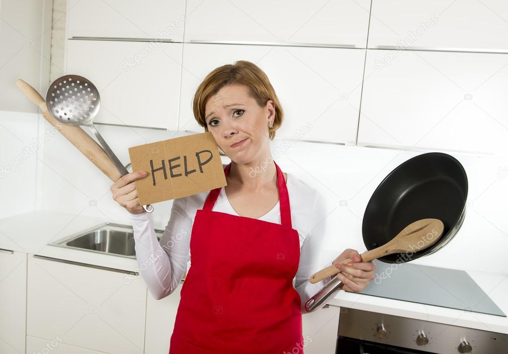 home cook woman in red apron at domestic kitchen holding pan and household in stress
