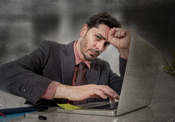 Attractive businessman in suit and tie working in stress at office grunge edgy edit — Stock fotografie