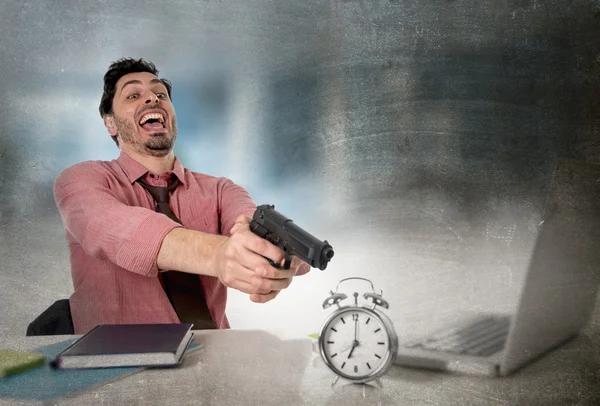 Businessman in stress at office computer pointing hand gun to alarm clock project deadline expiring — Stockfoto