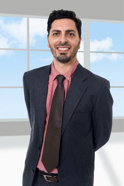 Corporate portrait of young attractive businessman at modern office — Stock Photo, Image