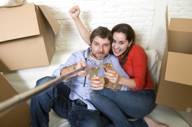 happy couple on couch having fun together celebrating champagne 