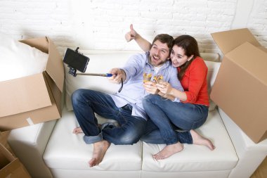 happy couple on couch having fun together celebrating champagne 