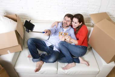 happy couple on couch having fun together celebrating champagne 