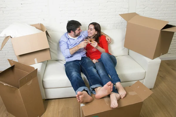 Happy American couple lying on couch together celebrating moving — Stockfoto