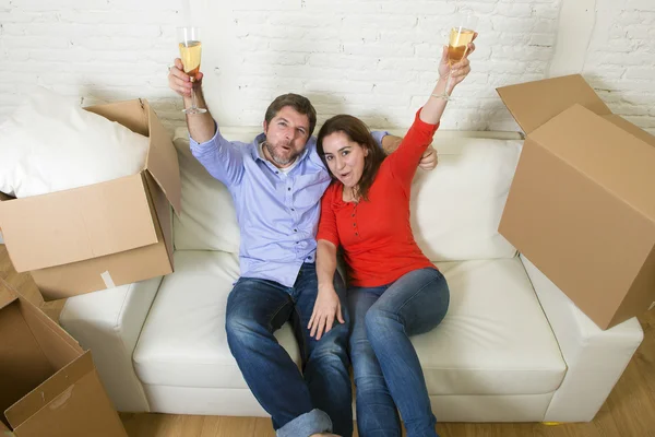 Happy American couple lying on couch together celebrating moving — Stockfoto