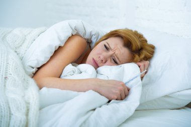 young woman  lying in bed sick unable to sleep suffering depress