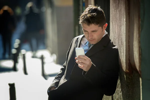 Hombre de negocios ocupado en traje y corbata usando el teléfono móvil que envía el mensaje o que consulta el Internet — Foto de Stock