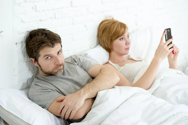 Couple in bed husband frustrated upset and unsatisfied while his internet couple in bed husband frustrated upset unsatisfied while wife using mobile phone wife is using mobile phone — Stock Photo, Image