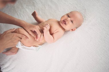 Annem bebek bezi değiştiriyor. Sevimli, duygusal, komik, yeni doğmuş bebek bebek beşikte yatıyor. Bebek eşyaları paketleme şablonu. Sağlıklı çocuk, hastane kavramı ve mutlu annelik. Bebek, bebek. Çocuk odası..