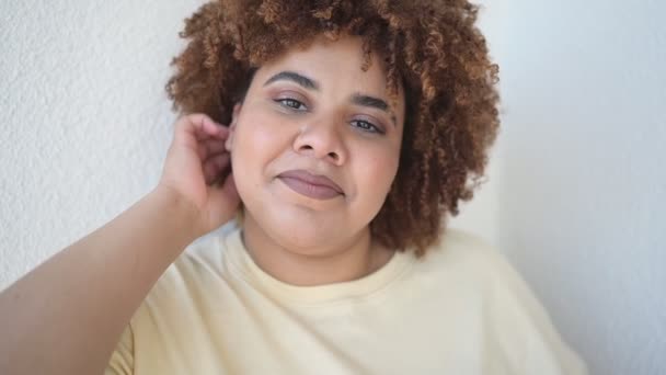 Schöne glücklich lächelnde kurvige plus Größe afrikanische schwarze Frau Afro-Haar mit Make-up posiert in beige T-Shirt auf weißem Hintergrund. Körperliche Unvollkommenheit, Körperakzeptanz, Body Positive und Diversity-Konzept — Stockvideo