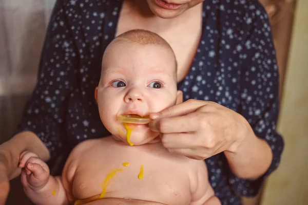 Madre y recién nacido divertido llanto emocional bebé desnudo bebé toma medicación líquida o jarabe de medicina antipirética de cuchara. Niño sano, concepto de hospital y maternidad feliz. Vivero. —  Fotos de Stock