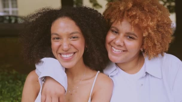 Close up portrait lovely beautiful happy lesbian African American couple hugging around city street landscape at summer. LGBT community concept. Female friends smiling enjoying love moments together — Stock Video