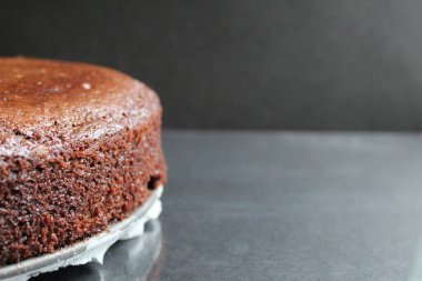 Koyu renkli çikolatalı kek. Çatallarla yakın plan. Siyah arka plan üzerinde yan görünüm ve metin için metin alanı.