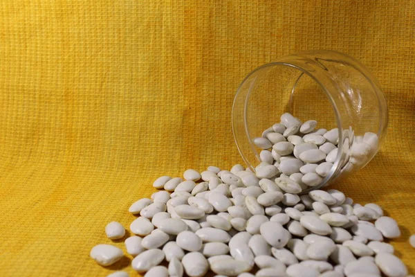 White Dry Beans Jar Lies Spilled Out Yellow Lemon Background — Stock Photo, Image