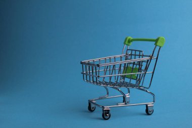 Telif alanı olan mavi arka planda bir alışveriş arabası. Satın alma. İş. Alıcı talebi. Dükkan. Alıcılar.