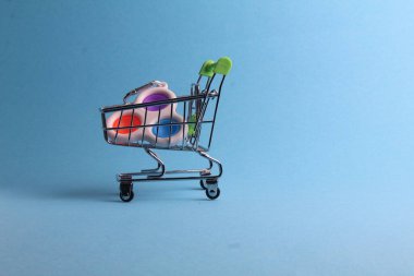The multi-colored. toy will wash popit the simple dimple in the shopping cart on a blue background with room for text. purchase. Melting.