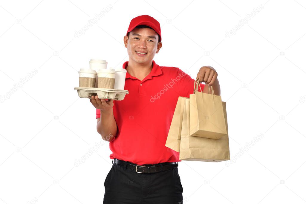 Asian delivery man in red uniform carry bags of food and drink in hands isolated on white background