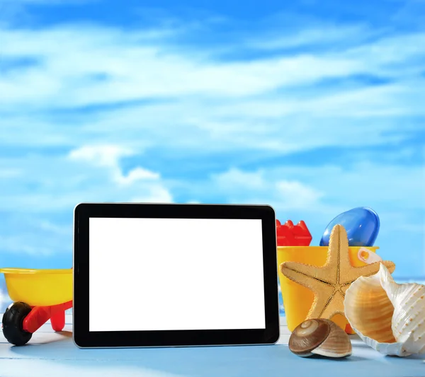 Tablet computer and beach toys — Stock Photo, Image