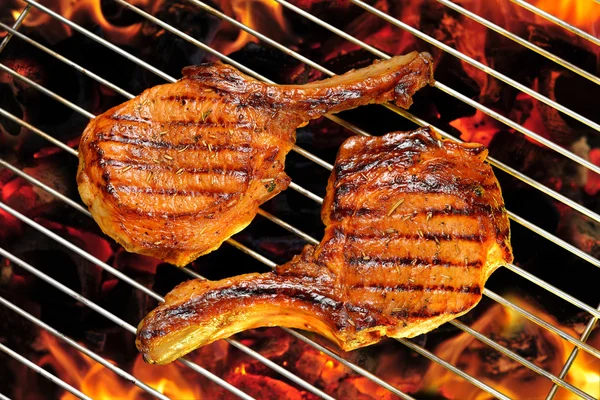 Grillet svinekoteletter på den flammende grill - Stock-foto