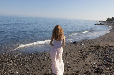 Sahilde duran genç kadın