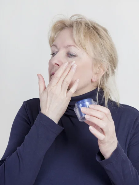 Mujer con crema de arrugas —  Fotos de Stock