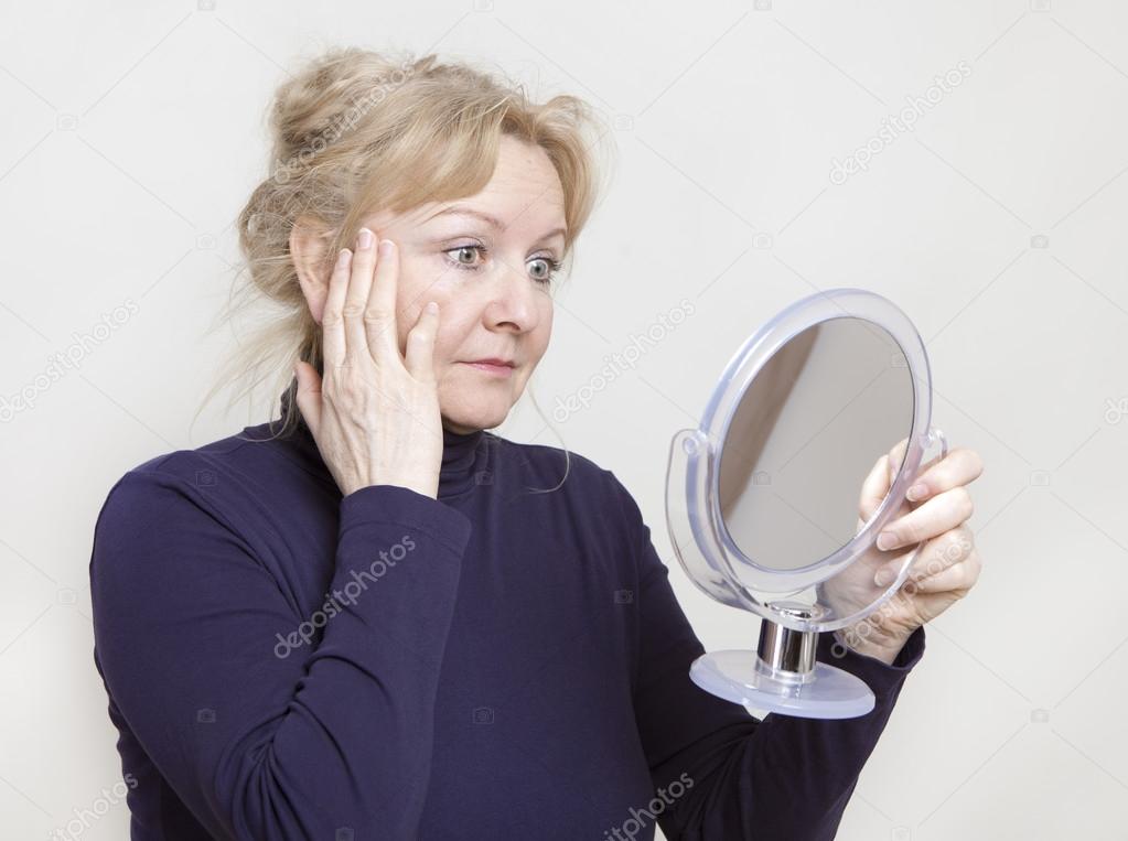 Senior looking in mirror