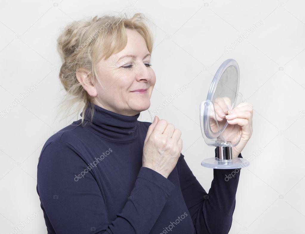 Senior with hand mirror