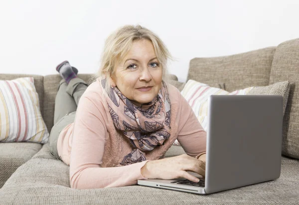 Frau schaut auf Laptop — Stockfoto