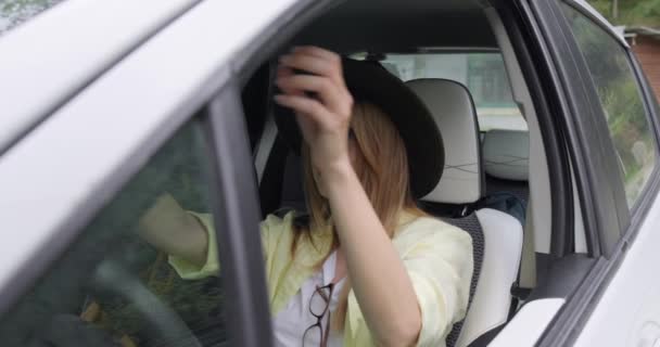 Girl Trying Black Hat While Sitting Car — Stock Video