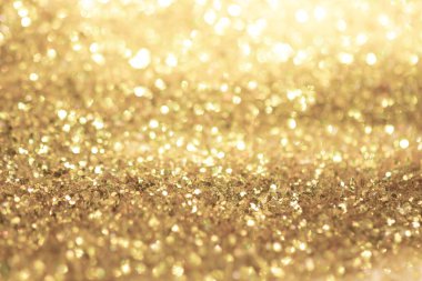 Altın ışıklı Noel arkaplanı. Soyut ışıltılı parlak arkaplan Bokeh odaklı altın ışıklarla