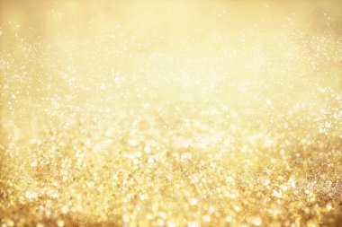 Altın ışıklı Noel arkaplanı. Soyut ışıltılı parlak arkaplan Bokeh odaklı altın ışıklarla
