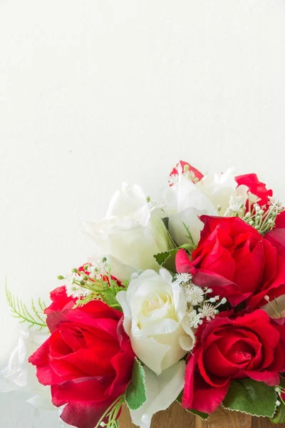 Rosas rojas y rosas blancas artificiales sobre un fondo blanco — Foto de Stock