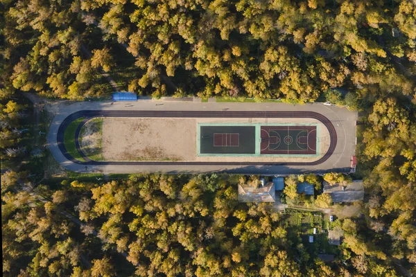 stadium in the woods. Shooting from a drone, top view in autumn