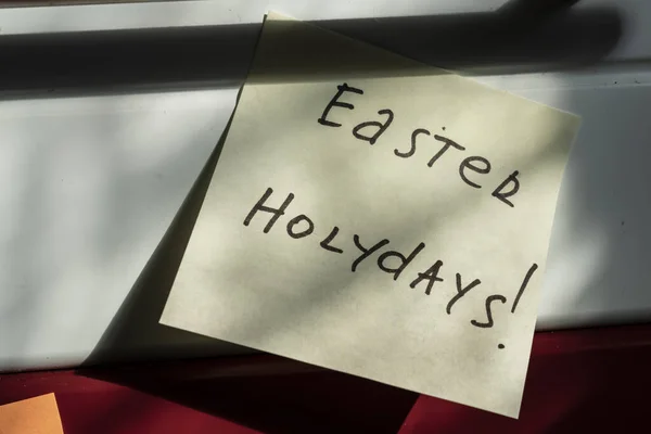 easter holidays, an inscription with a marker about the upcoming holiday in the office or a message reminder to family and friends