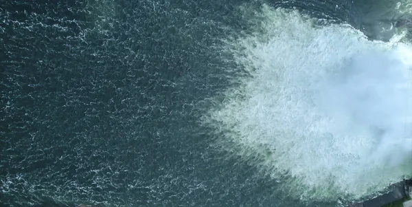 water flow, waterfall top view beautiful textured background, water drain on the dam on the Yenisei river. aerial drone