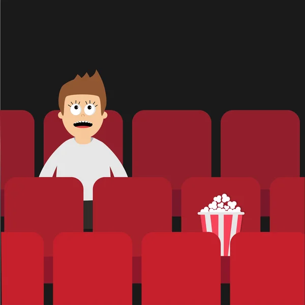 Hombre de dibujos animados sentado en el cine . — Vector de stock