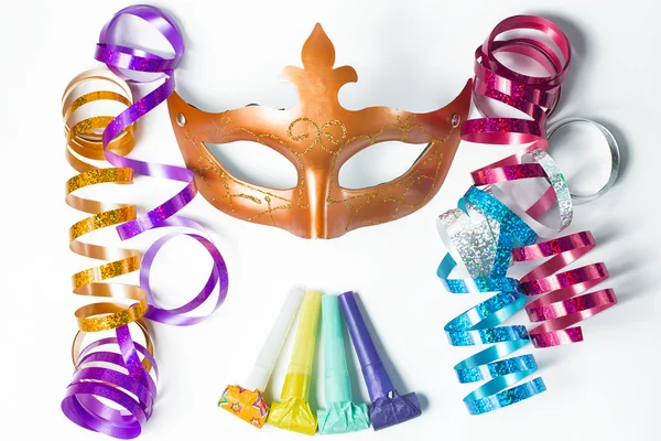 Carnival mask with colorful streamers and party horns on white b — Stock Photo, Image