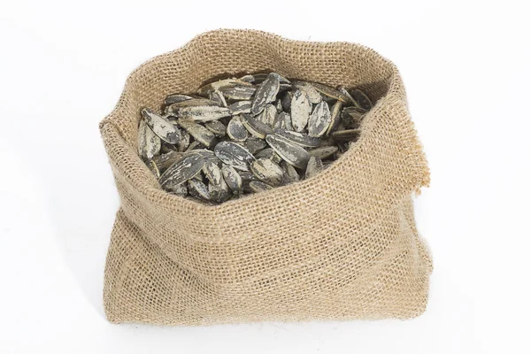 Semillas de girasol en saco sobre fondo blanco —  Fotos de Stock