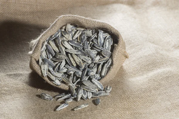 stock image Pipas salted sunflower on sack in the foreground