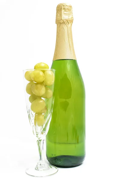 Bottle of champagne with twelve grapes of luck — Stock Photo, Image
