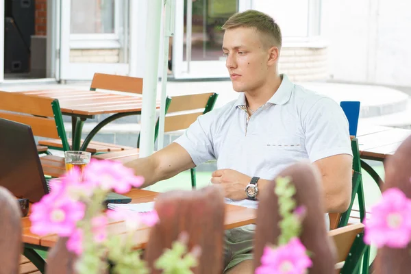 Young man sitting in cafe — Stock Photo, Image