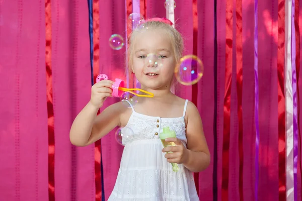 Happy little girl with soap bubbles — Stock Photo, Image