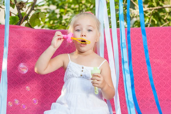 Happy little girl with soap bubbles — Stock Photo, Image