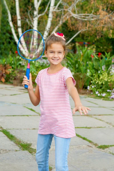 Menina bonito com raquete ao ar livre — Fotografia de Stock