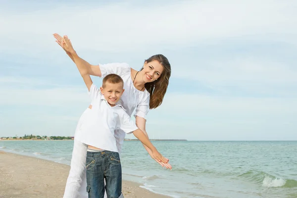 Moeder en haar zoon plezier op het strand — Stockfoto
