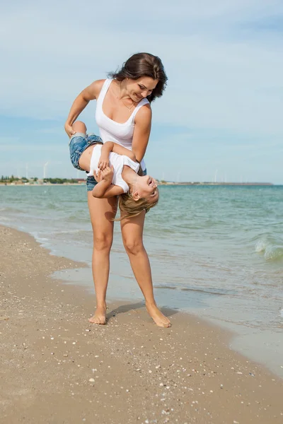 Mutter und ihre Tochter amüsieren sich am Strand — Stockfoto